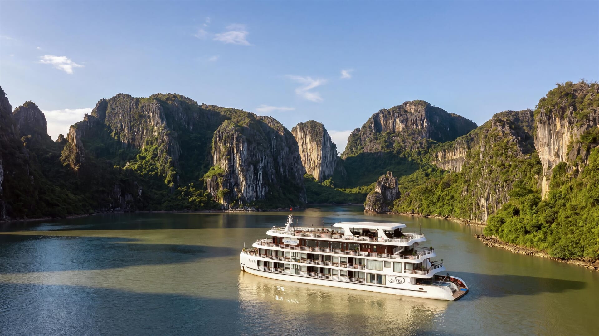 Hermes Premium Cruises sailing in Halong Bay in November among limestone towers