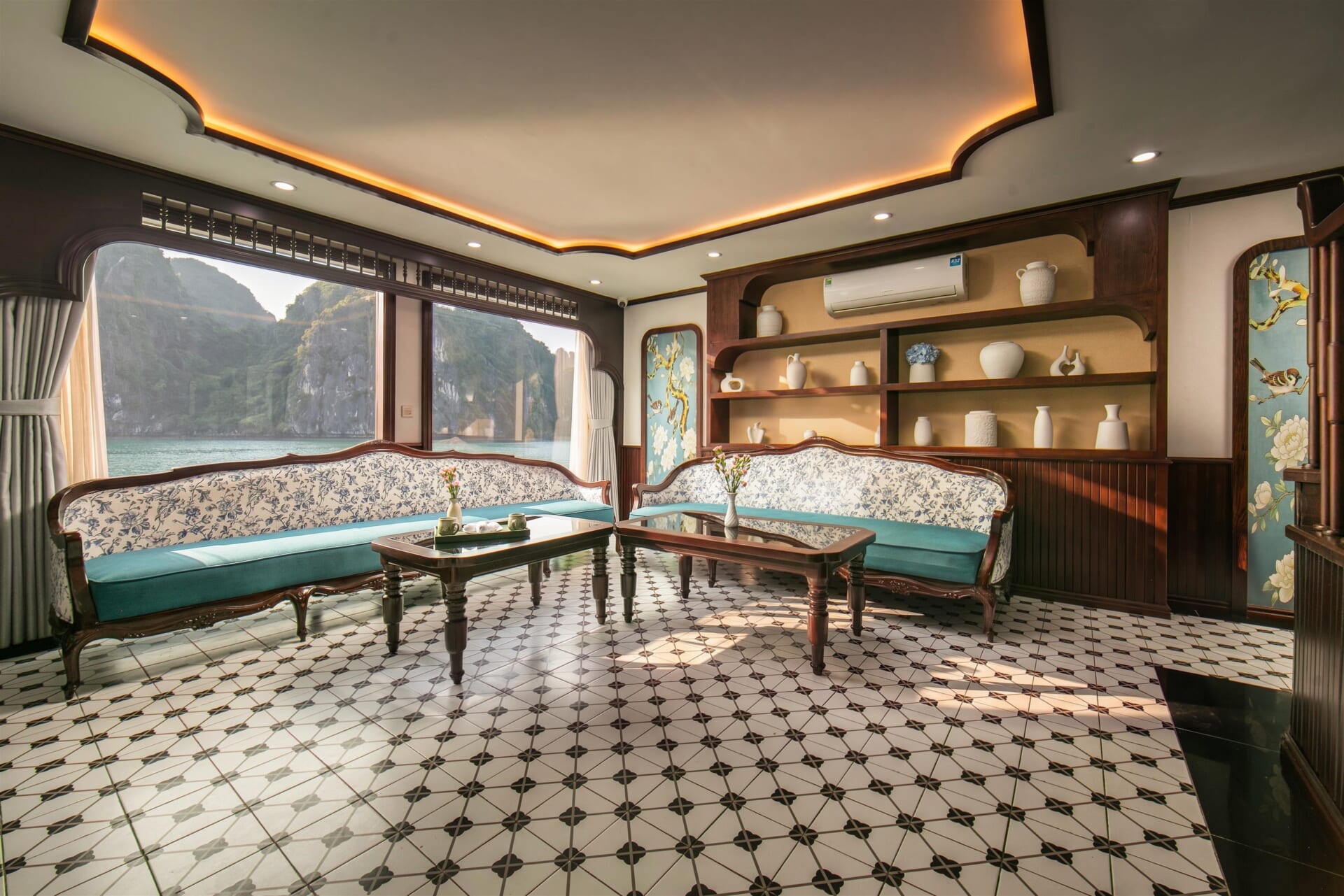 Lounge seating area on Hermes Premium with large windows looking onto Halong Bay