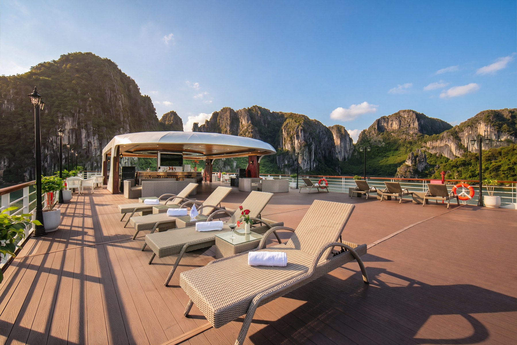 Sundeck of Hermes Premium with sun loungers and towels for a Halong Bay cruise packing list