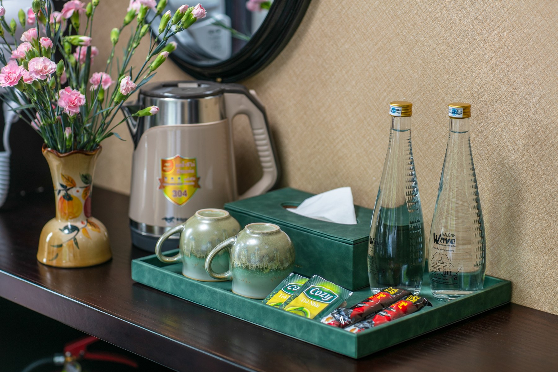 Tray in a Hermes Premium cabin with a kettle, tea cups and two glass water bottles